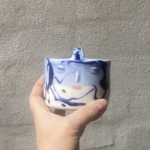 unik i glasur og skæv og oval i formen. Håndlavet og drejet keramik. Porcelæn. Lille personlighed. unik kop med ansigt. med særlig glasering cobolt blå..