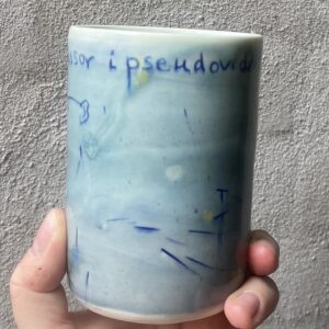 unik i glasur og form. Håndlavet og drejet keramik. Porcelæn. en lille personlighed. unik kop med glasering. ansigtskop. teks på koppen- professor i pseudovidenskab.