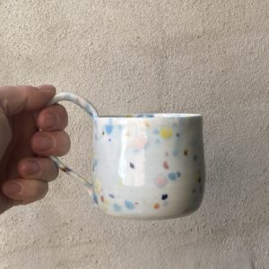 Konfettikop med svagt lyseblåt skær. unik i glasur og form. Håndlavet og drejet keramik. Porcelæn. unik kop med glasering.